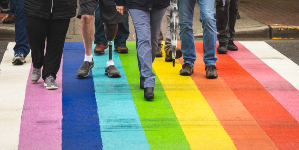 Future Of Work: Why Inclusivity Is Good For Business - image of people crossing the road on a rainbow colored crossing.