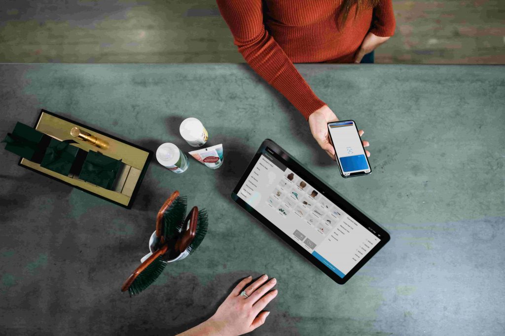 A person using their smartphone at checkout.